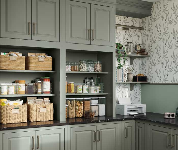 light green kitchen cabinetry with open shelving displaying various kitchen ingredients